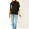 Woman in black cashmere turtleneck