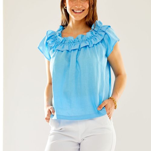 Woman in pacific blue ruffled top