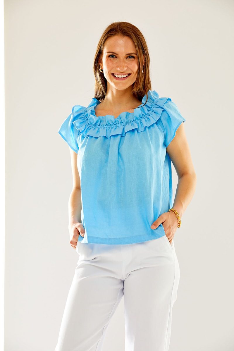 Woman in pacific blue ruffled top