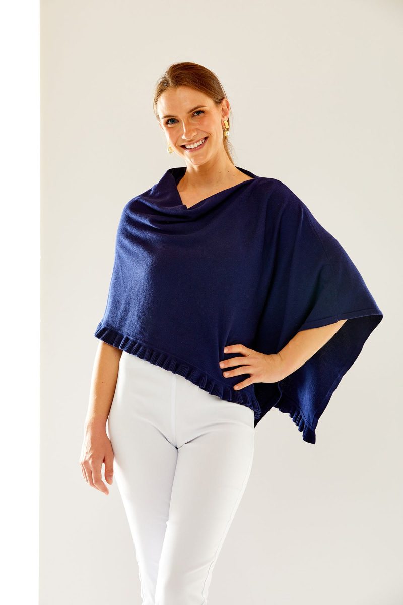 Woman in navy ruffle poncho