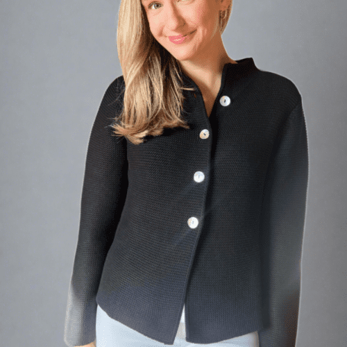 Woman in black button front nock neck cardigan