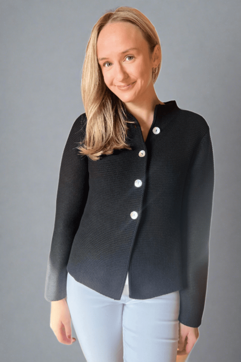 Woman in black button front nock neck cardigan