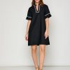 Woman in black short sleeve dress