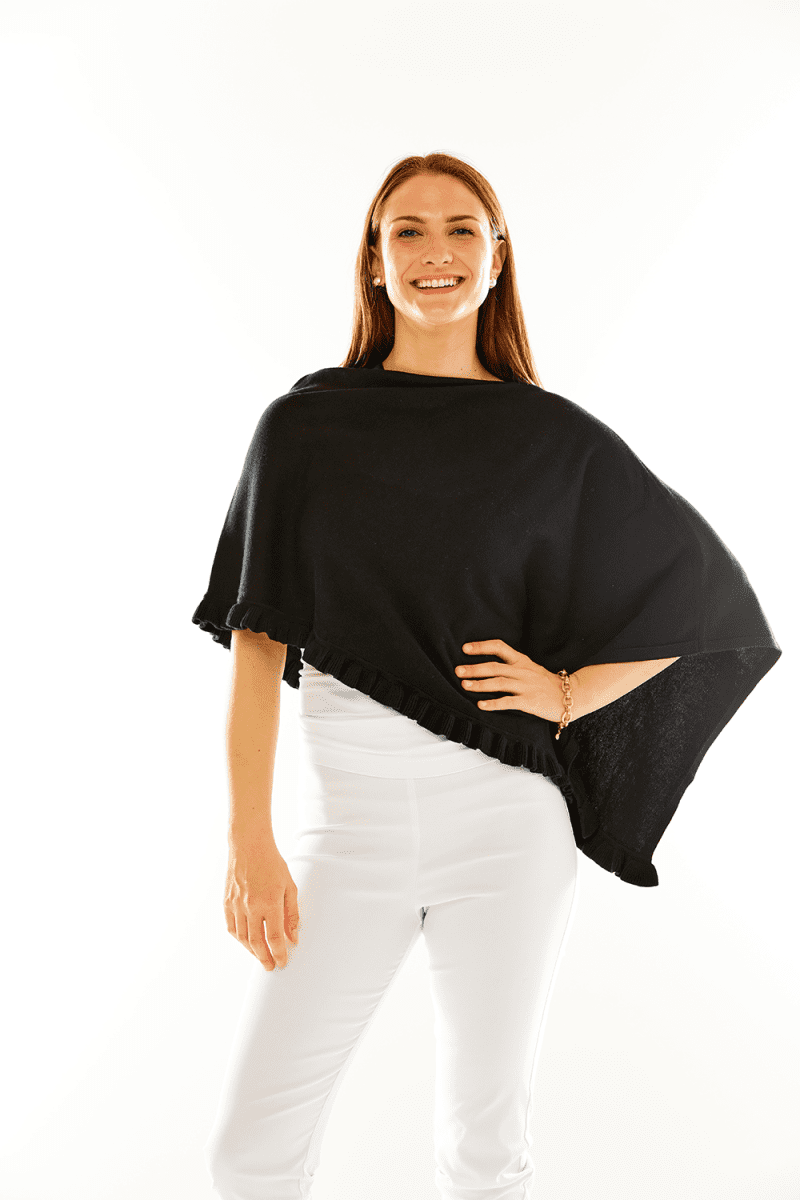 Woman in black ruffle poncho