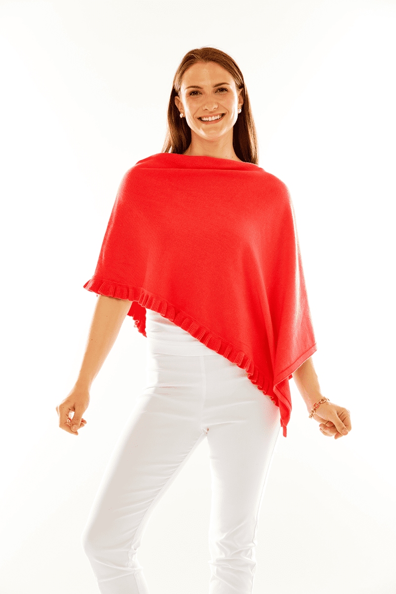 Woman in coral ruffle poncho