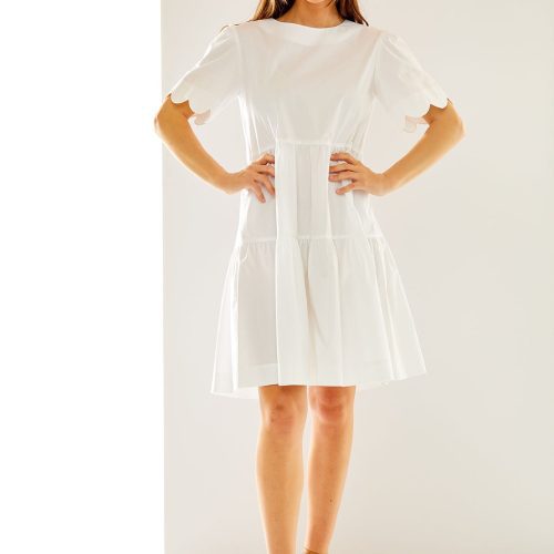 Woman in white scallop dress