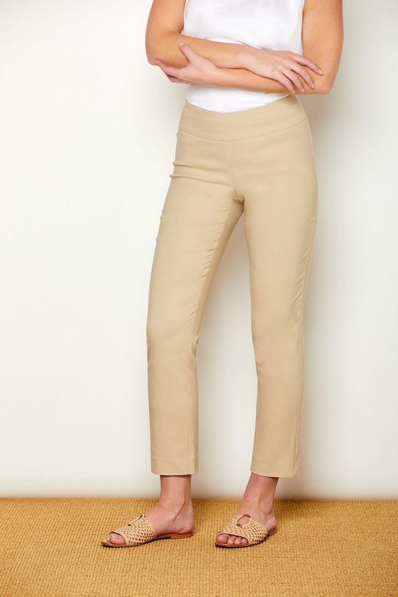 Woman in fitted sand colored pants