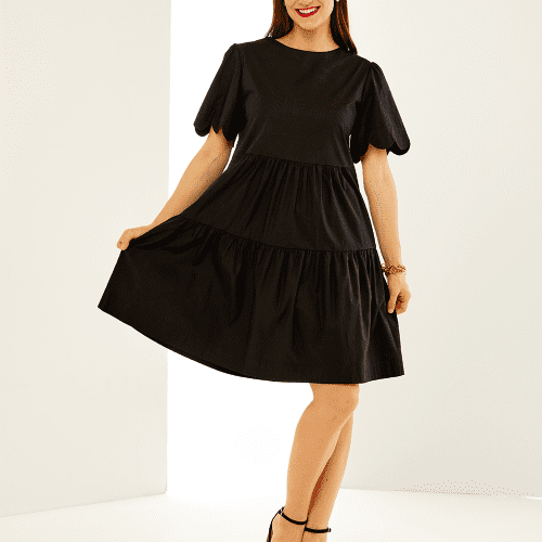 Woman in black scallop dress