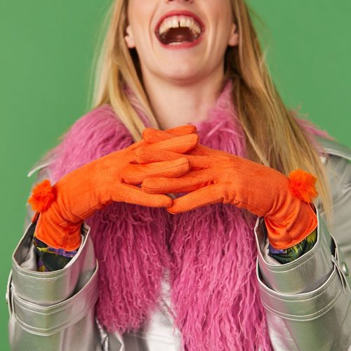 Woman in orange faux suede faux fur gloves