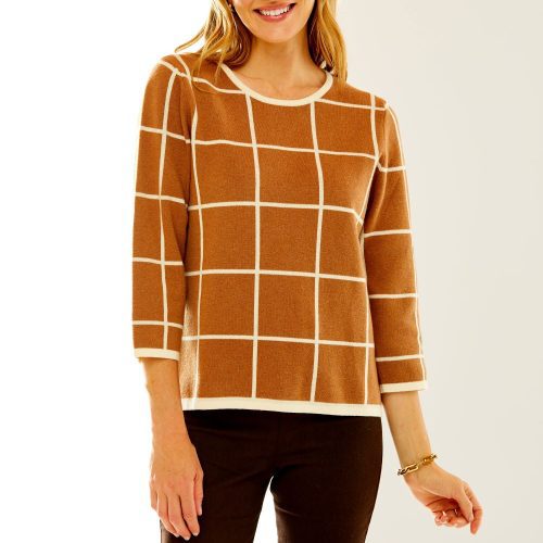 Woman in camel/ivory windowpane sweater