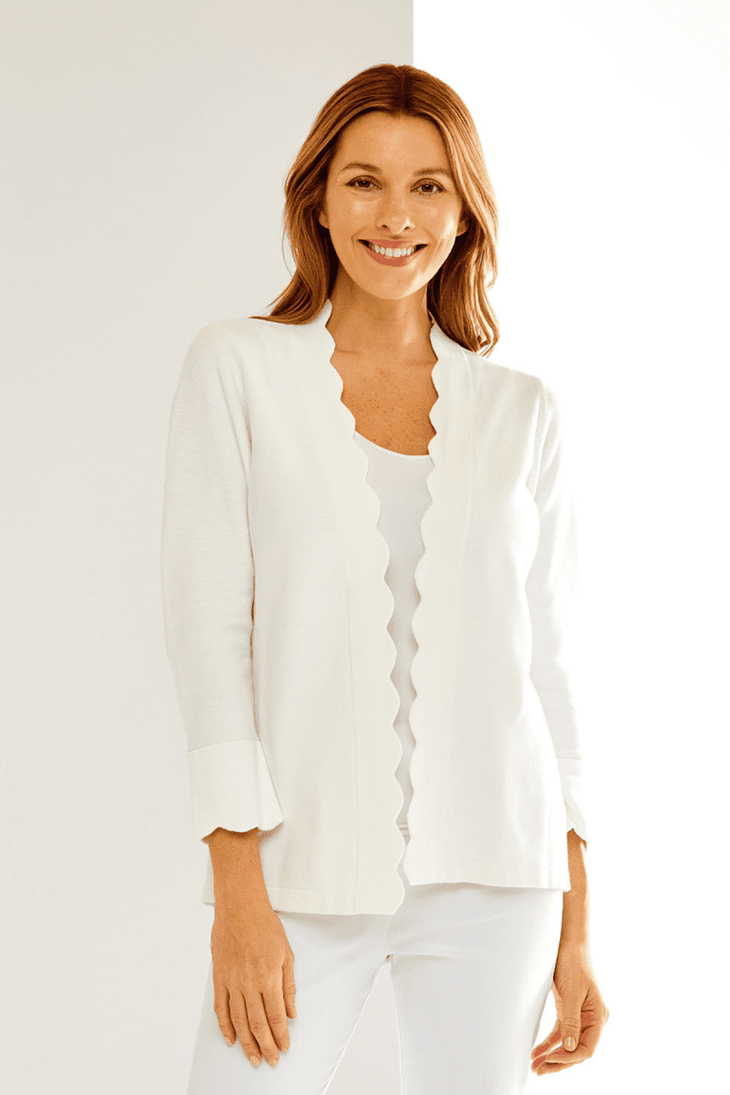 Woman in white scallop cardigan